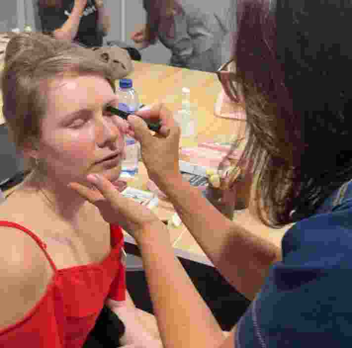 A person having their makeup done.