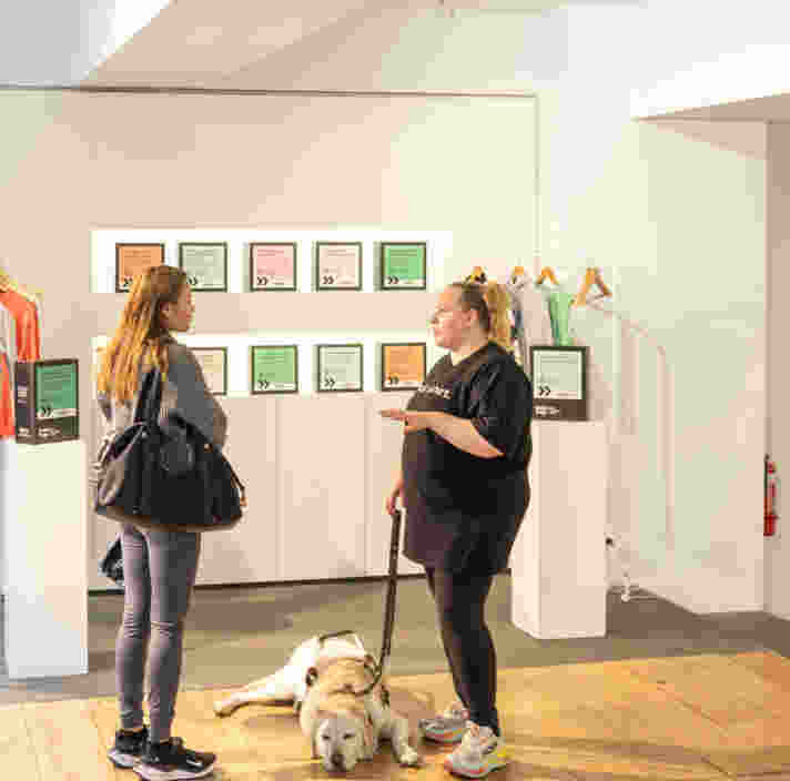 Two people standing and talking.