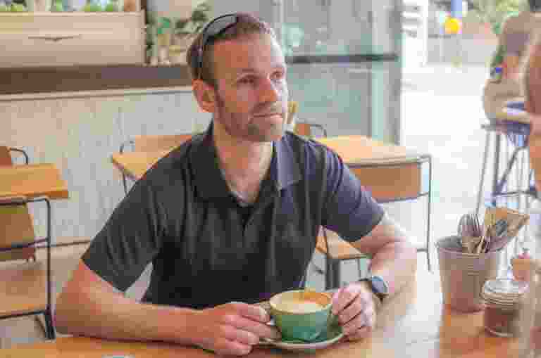 Dan Searle sitting at a cafe.