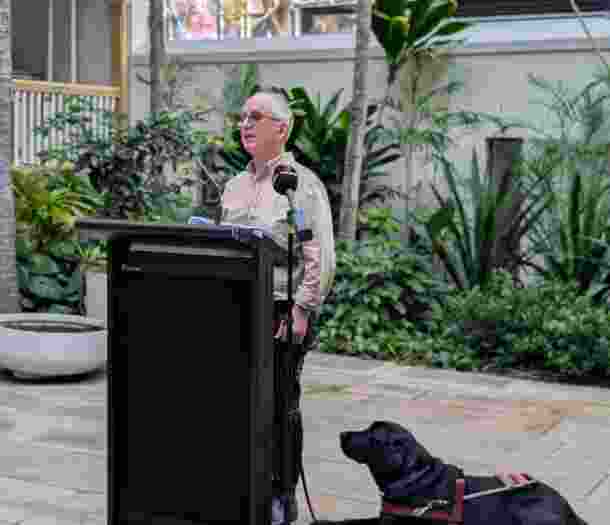 Lived Experience Presenter standing in Parliament.