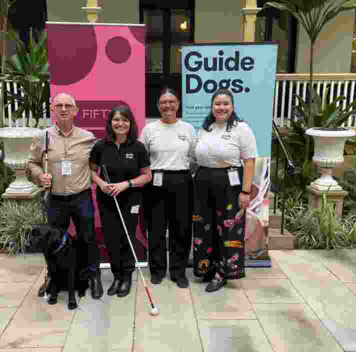 Members of our social change team stand in front of Parliament.