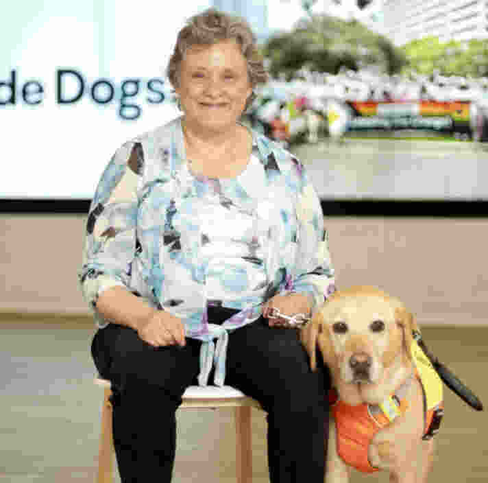 Amanda sitting with her yellow Labrador Guide Dog Sadie.