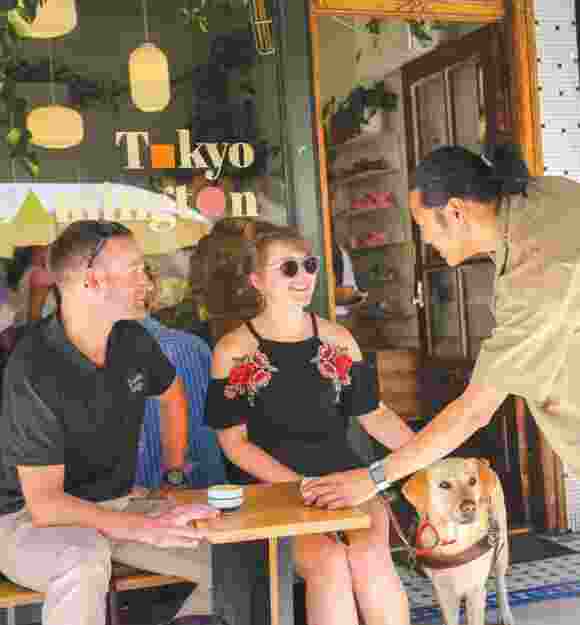 Dan and Aimee sitting at a cafe.