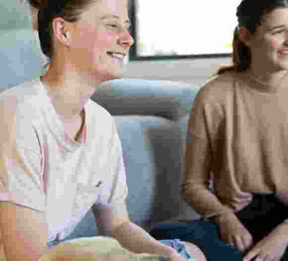 Two people sitting and laughing together.