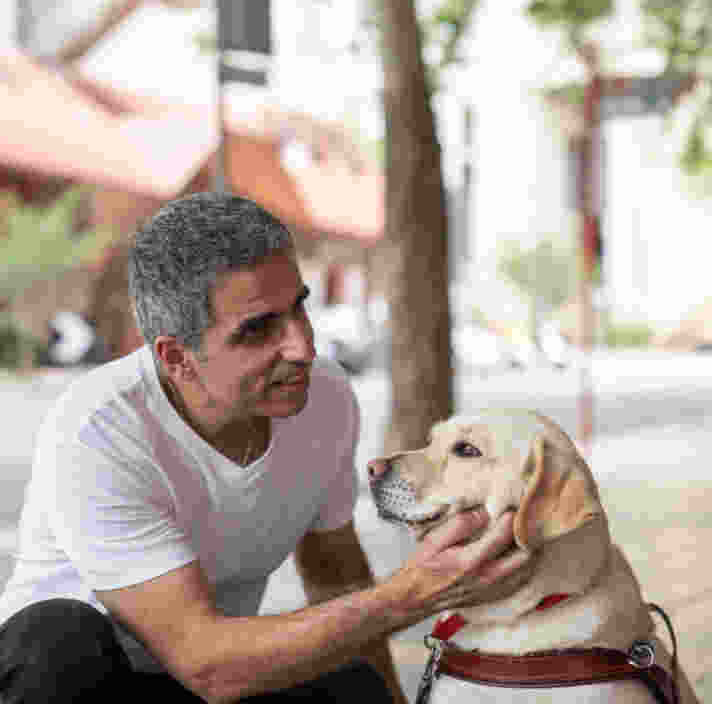 Andrew Christou with his yellow Guide Dog.