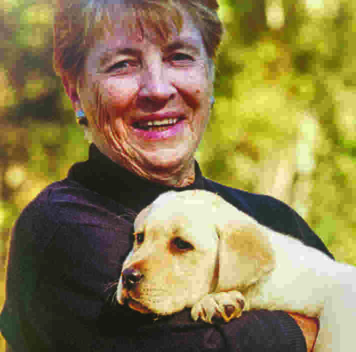 Ann and a yellow labrador puppy