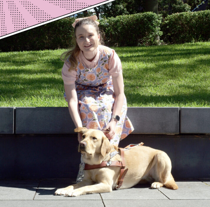 Charlotte sitting outside with yellow Labrador Guide Dog Holly