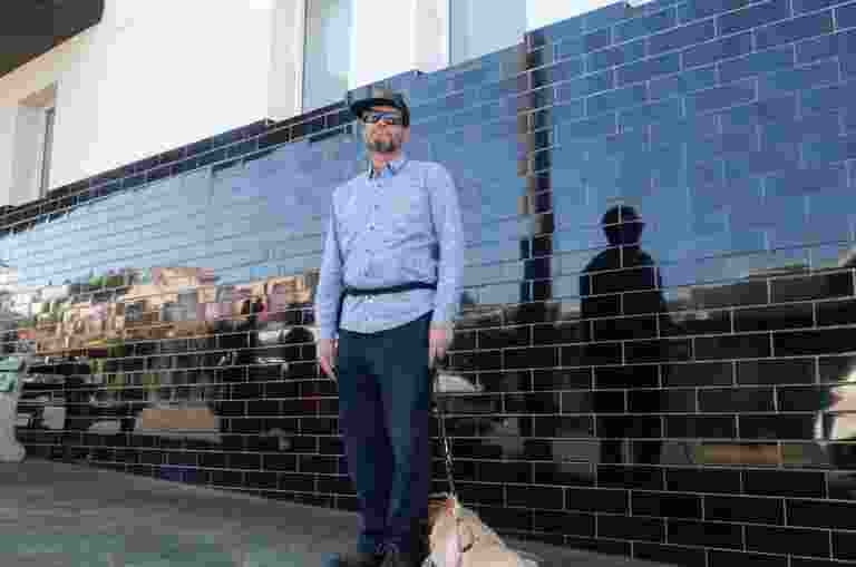 Brian standing outside with yellow Labrador guide dog