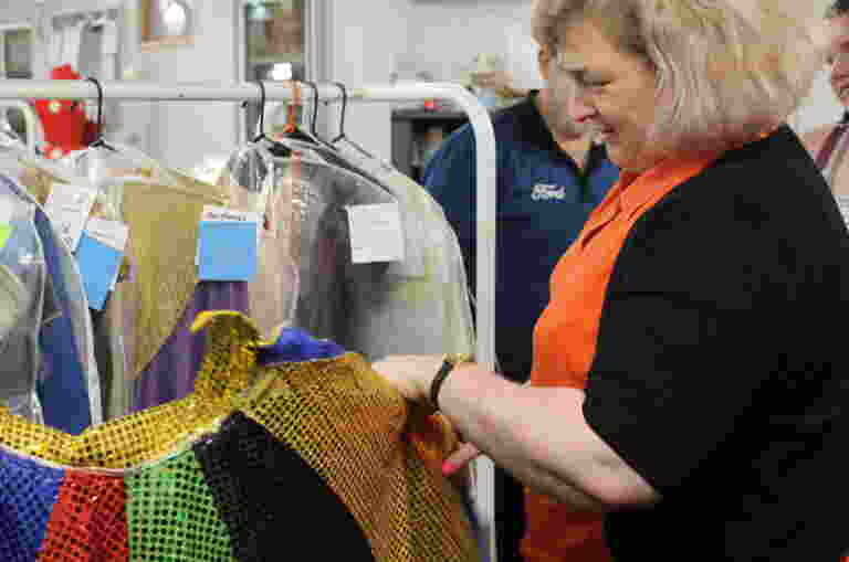 A Guide Dogs client touches the costumes at Stardust castle.