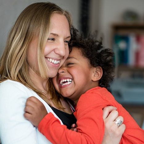 Mother And Son smiling and hugging on a lounge