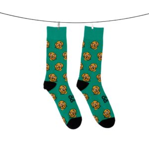 Green socks featuring a dog face pattern and the words "Good Dog," displayed on a line.