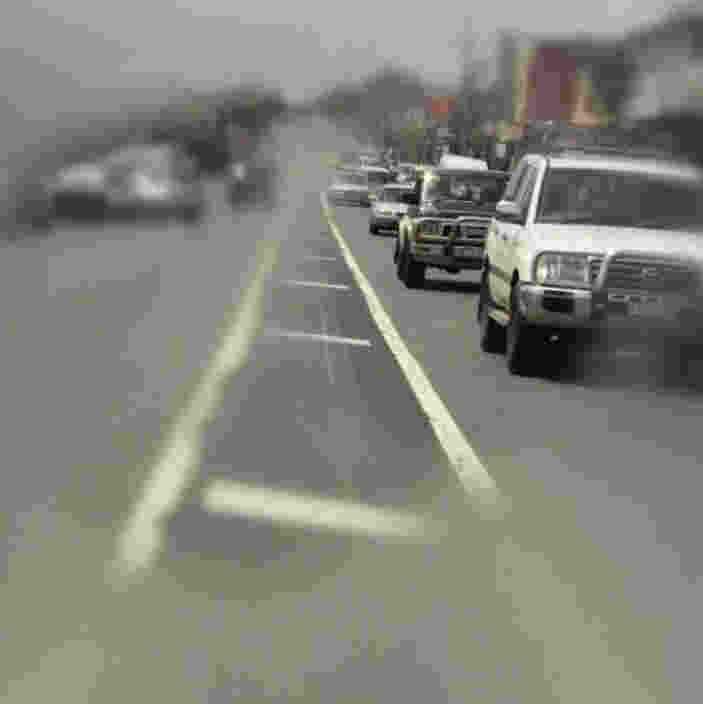 Cars driving on a road with blurry edges, creating a sense of motion.