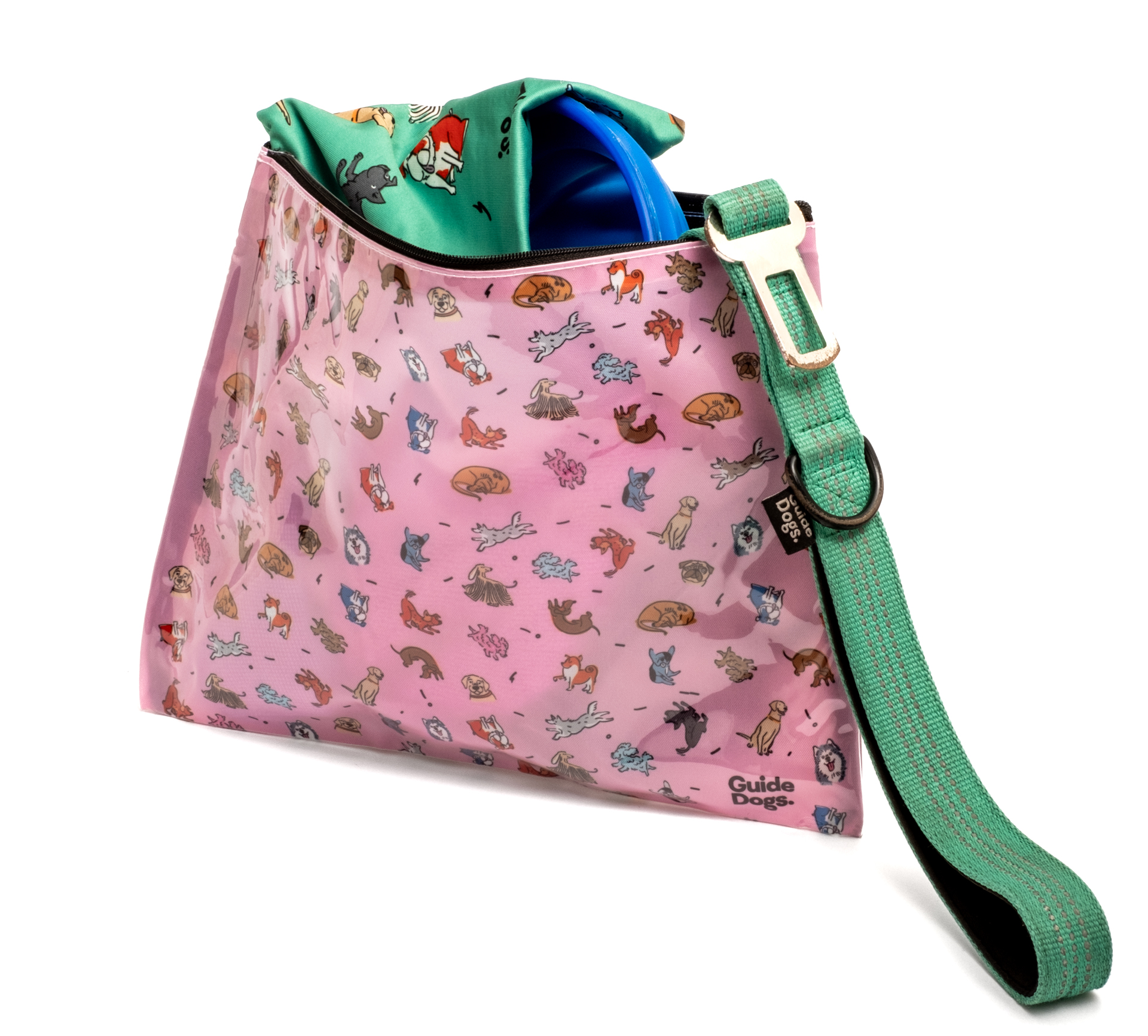 A pink bag with cartoon dogs, a green strap, and a green fabric partially visible inside.