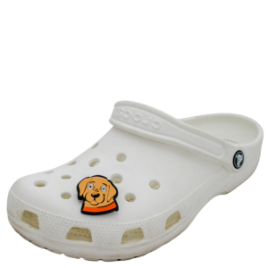 White clog-style shoe featuring ventilation holes and adorned with a Shoe Charm in the shape of a dog face.