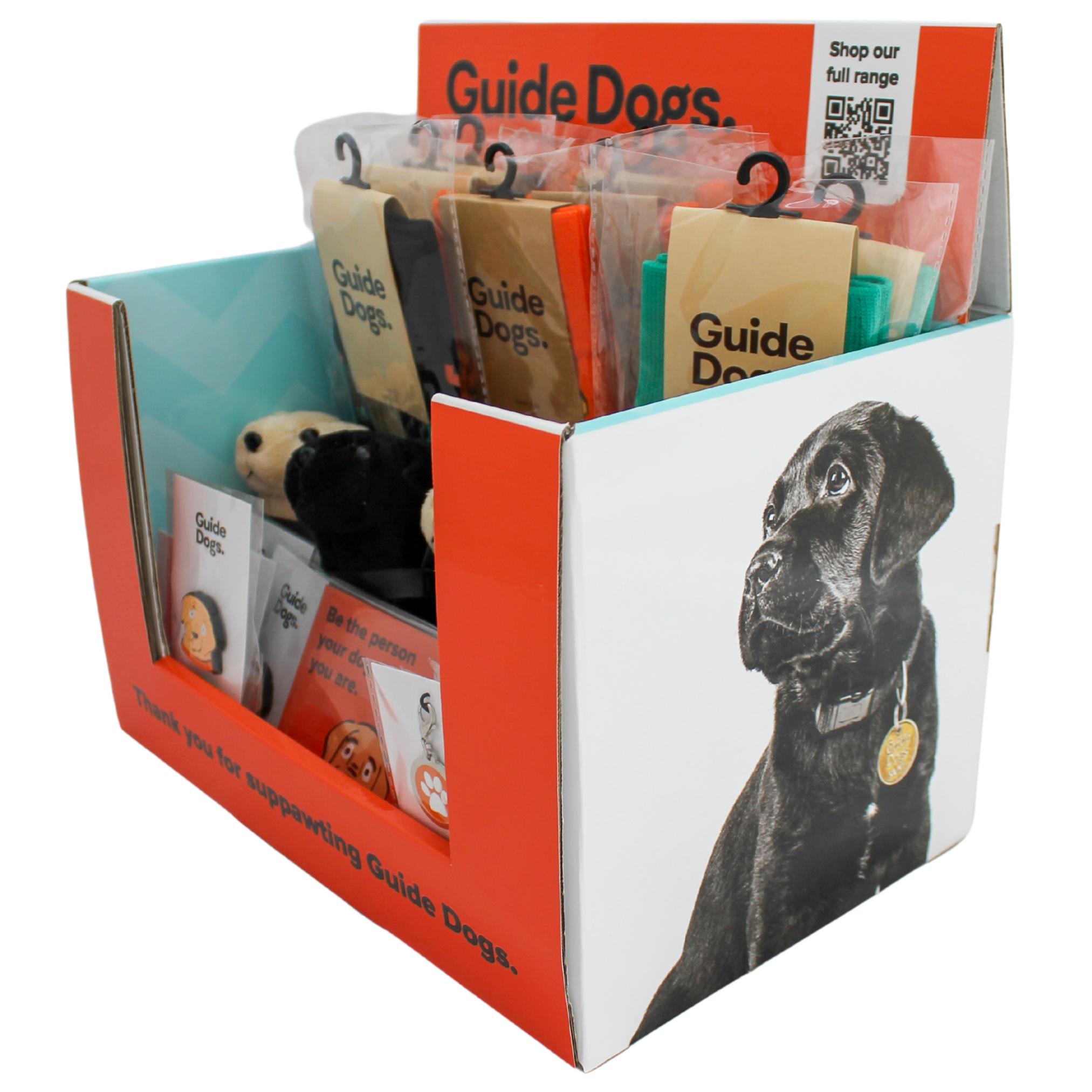 Guide Dogs Fundraising Pack: A display box with guide dog merchandise, like toys and stickers, featuring a black labrador photo and a QR code to view the full range.