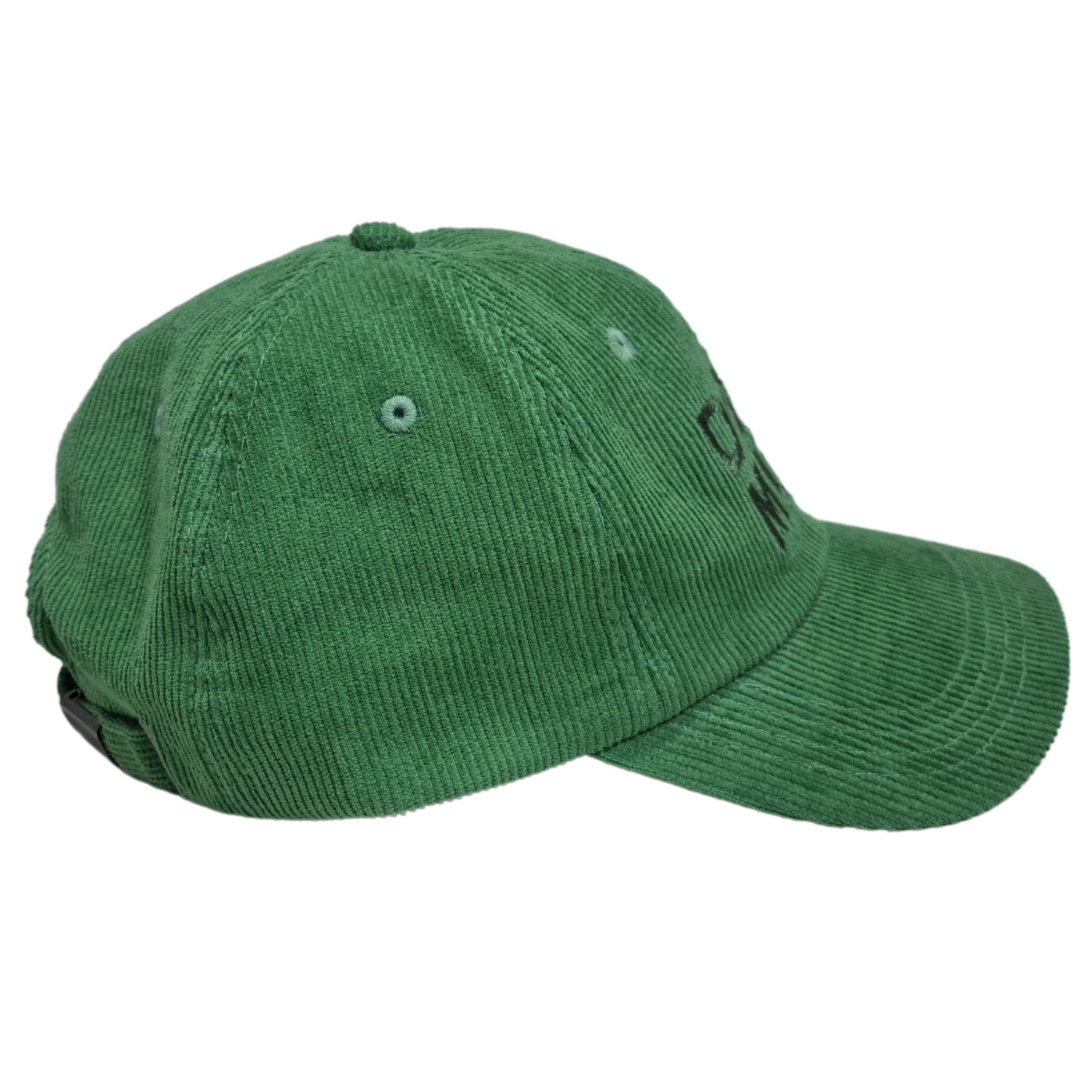 Green Corduroy cap side view with a curved brim and an adjustable back strap.