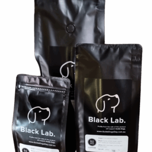 Three bags of Soho Coffee and Hot Chocolate, featuring a white dog outline on black packaging, shown in different sizes together.