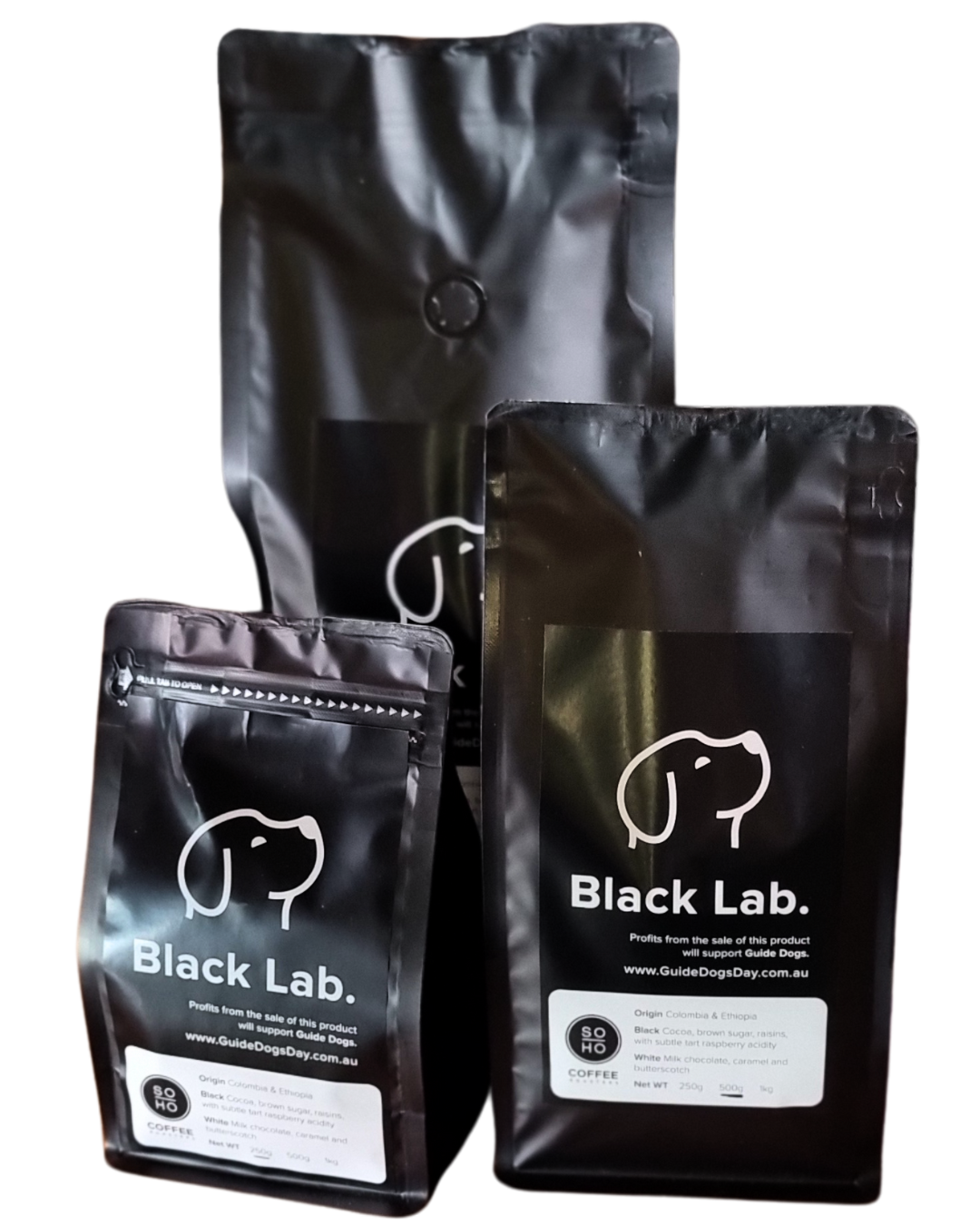 Three bags of Soho Coffee and Hot Chocolate, featuring a white dog outline on black packaging, shown in different sizes together.
