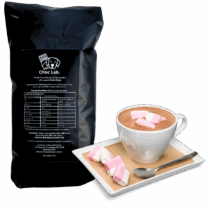 A cup of Soho Coffee and Hot Chocolate topped with pink and white marshmallows sits on a saucer beside extra marshmallows.