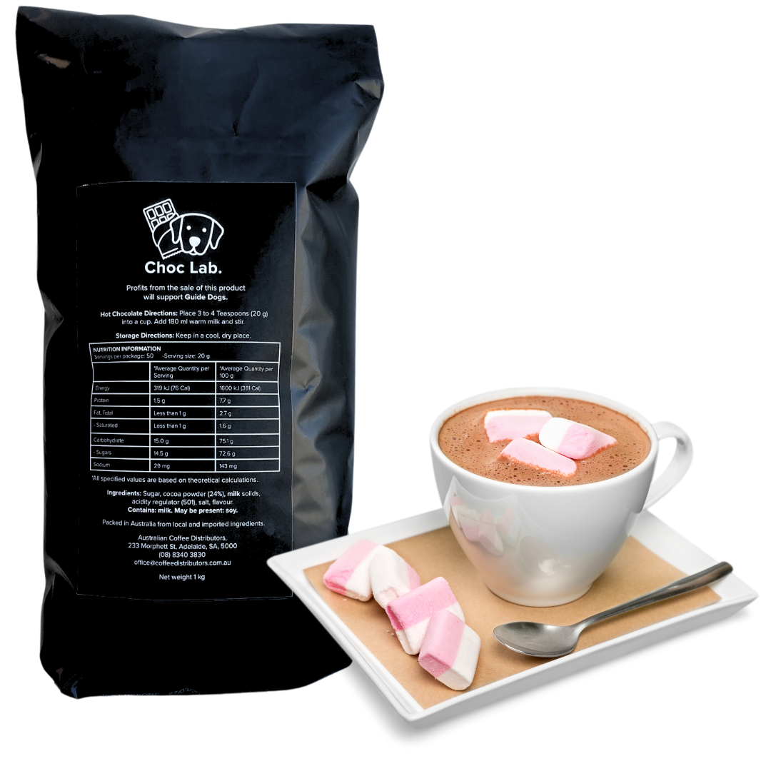 A cup of Soho Coffee and Hot Chocolate topped with pink and white marshmallows sits on a saucer beside extra marshmallows.
