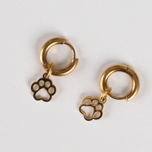 Earrings - Huggie Paws: Gold hoop earrings featuring dangling paw print charms, shown on a simple light background.