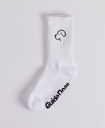 The Crew Socks - White feature a minimalist black outline of a dogs head near the top and Guide Dogs printed on the sole.