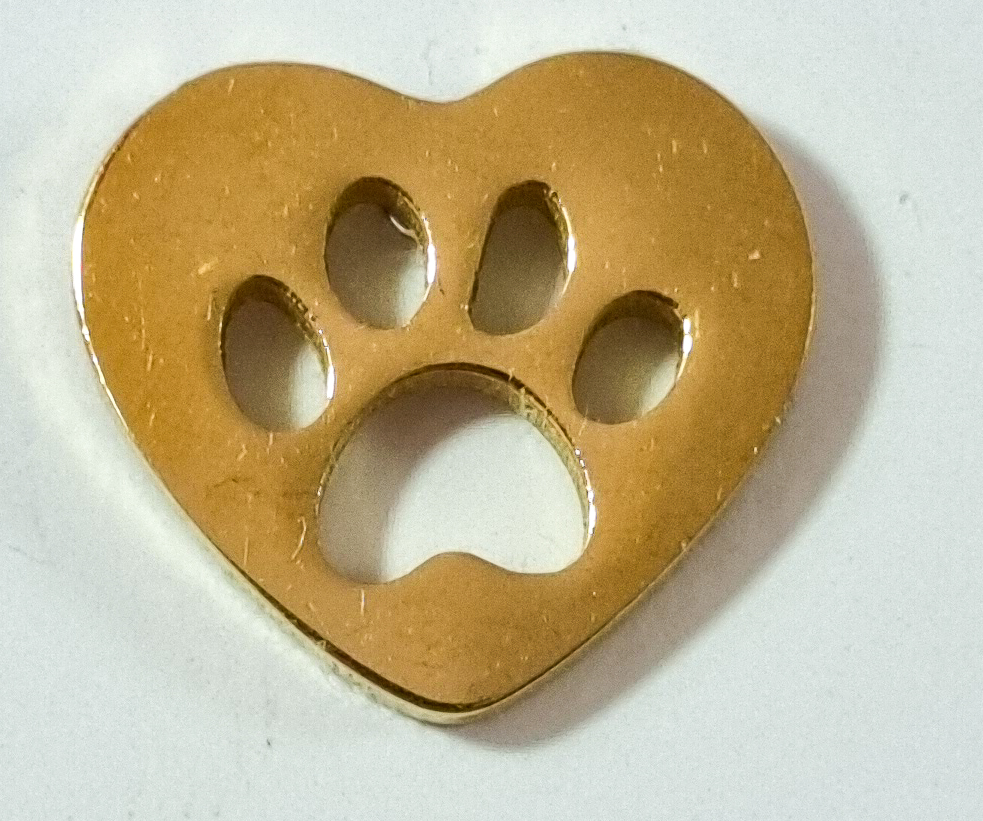 Gold heart-shaped "Earrings - Heart" with a paw print cutout in the center, displayed on a white surface.