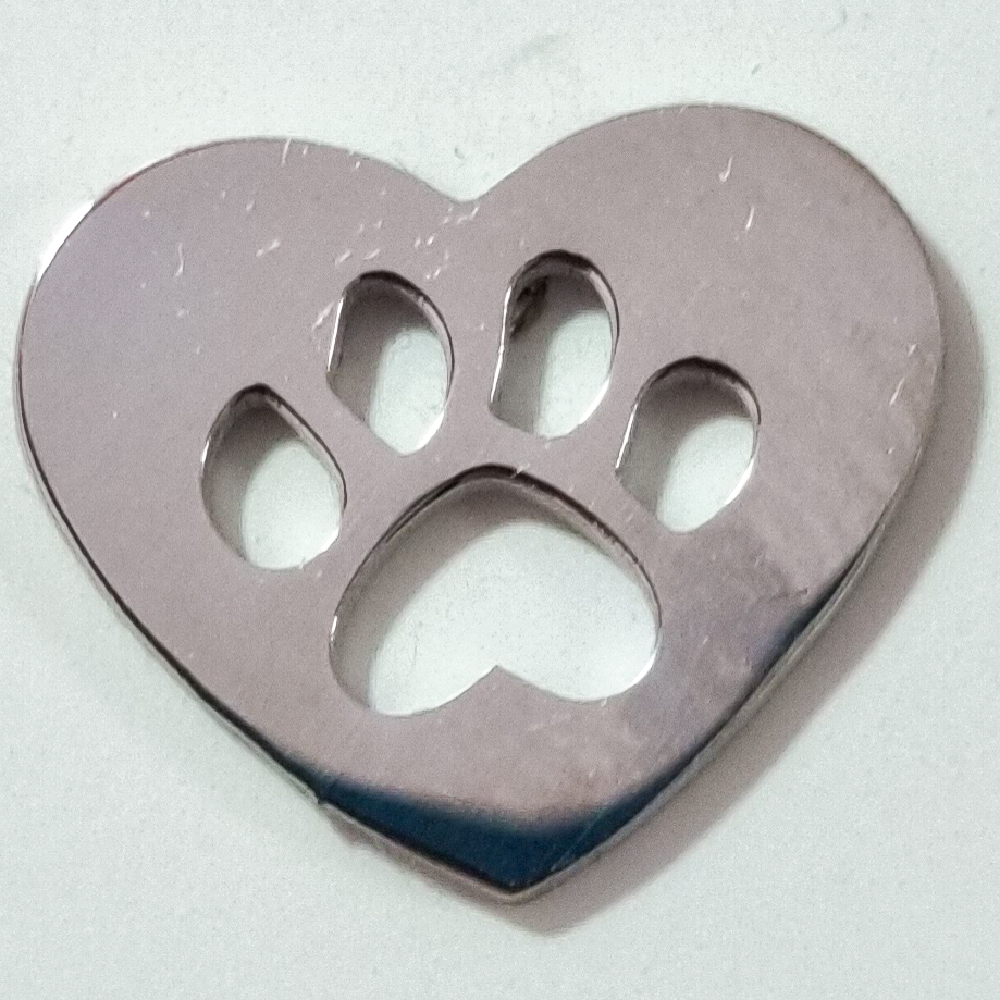 A pair of silver heart-shaped earrings with a paw print cutout in the center, displayed on a white surface.