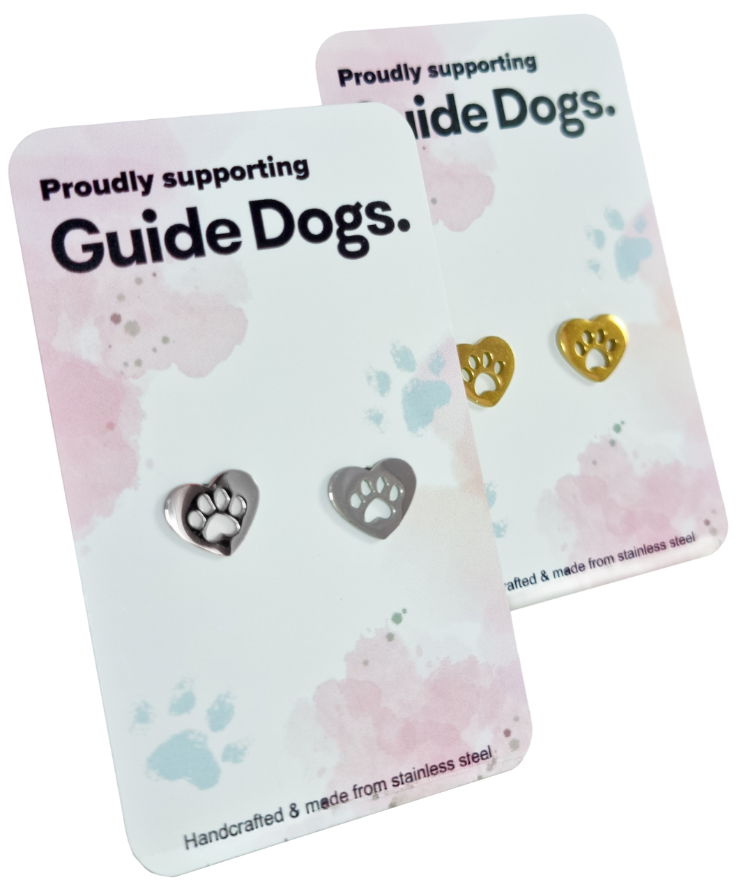 Two display cards featuring stainless steel heart-shaped earrings in silver and gold, labeled Proudly supporting Guide Dogs.