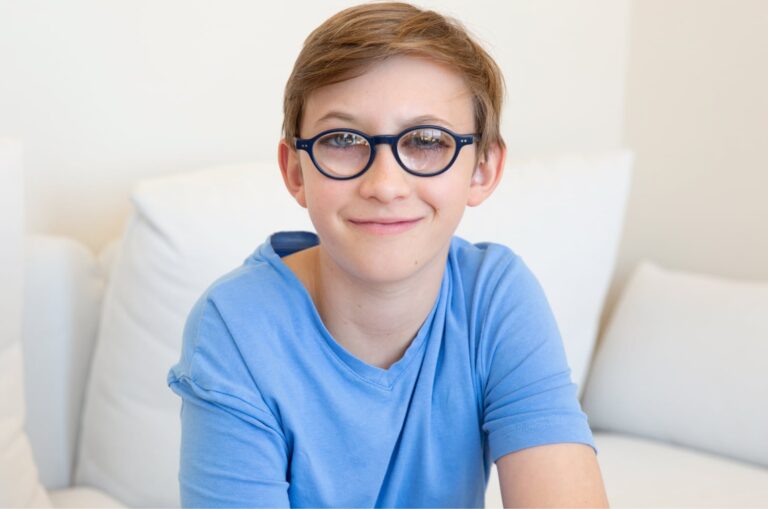 A young child looking at the camera smiling.