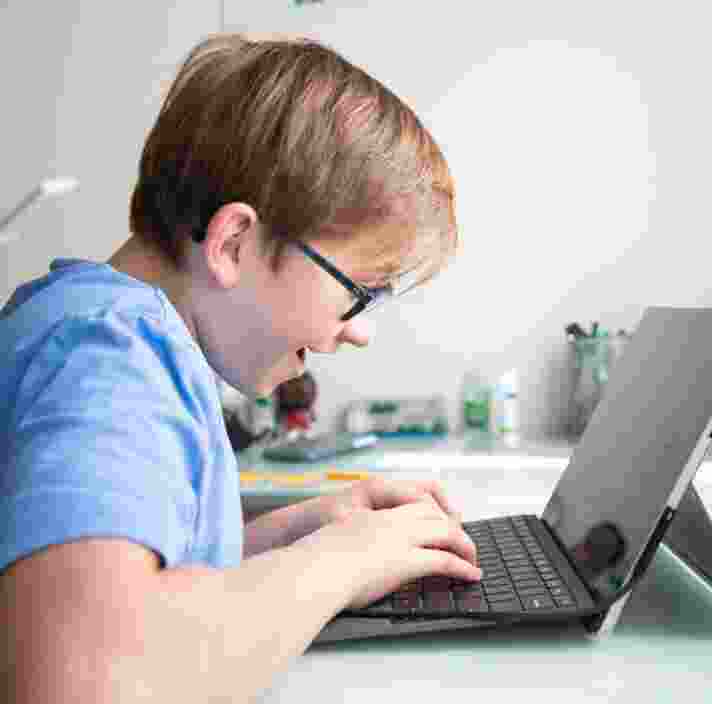 Image of young boy on laptop