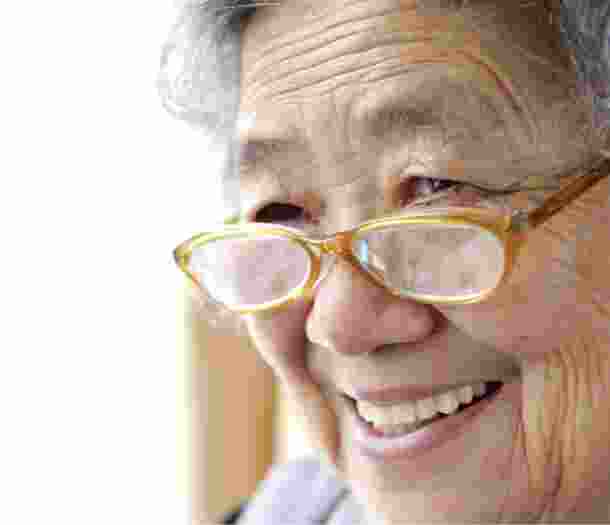 A close up of an older adult person who is smiling.