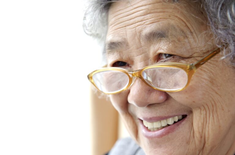 A close up of an older adult person who is smiling.