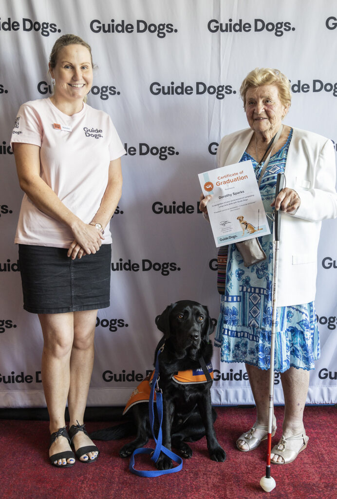 Dorothy Sparks and Guide Dog Quora, with a Guide Dogs team member.