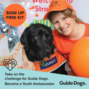 [Image description: a girl hugging a black Labrador in an orange training coat. Blue banner at the bottom with black text. Text reads ‘Take on the challenge for Guide Dogs. Become a Youth Ambassador.’ An orange circle at the top with black text. Text reads ‘Sign up. Free kit.’]