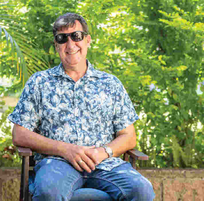 Image of Jason sitting, smiling at the camera.