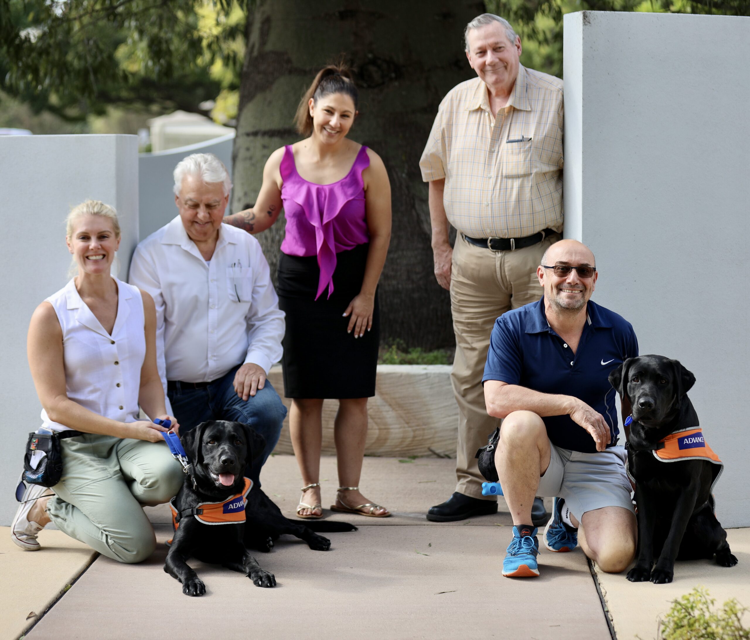 Guide Dogs-in training, Barron and Barnett are seen alongside their Puppy Raisers as well as a staff member from Guide Dogs and two representatives from Barron Barnett Lodge