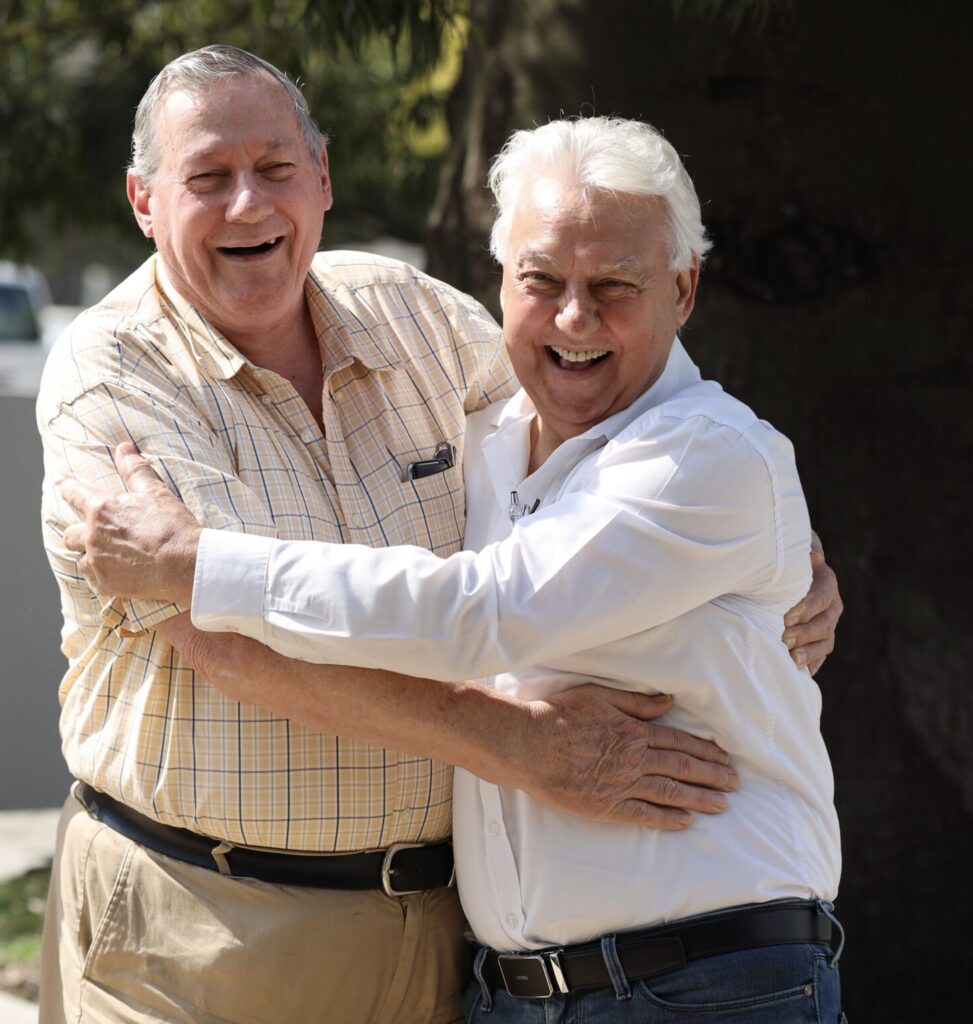 John Zamofing (pictured right) and John Den Dulk (pictured left) representatives from Barron and Barnett Lodge embracing each other and laughing towards the camera