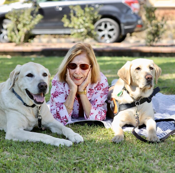 Image of Helen, Hank and Sparky sitting on the grass.