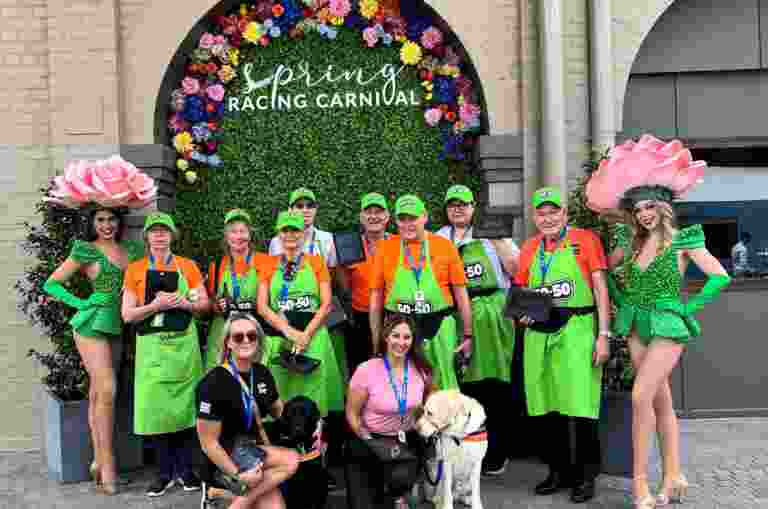 A group of volunteers in green aprons