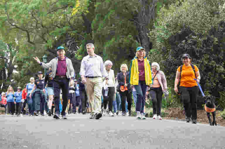 A crowd of people are pictured walking with CEO Jock Beveridge, Professor Nimmo and Her Excellency the Honourable Dr Jeannette Young, Governor of Queensland leading the way.