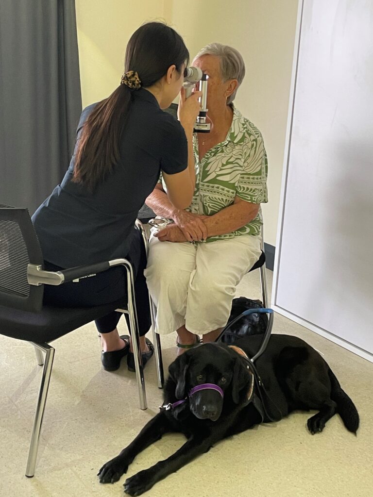 Seated on the left, 5th year QUT Optometry student, Allison Jaehee Kim, with client Sue Bolton-Wood, seated on the right. Allison is conducting an Anterior Ocular health examination with slitlamp
