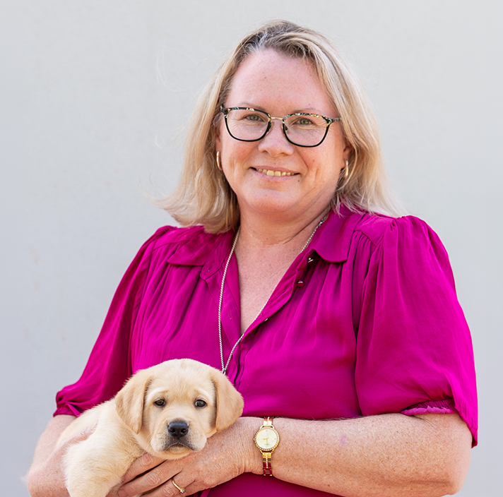 Headshot image of Amanda holding a puppy.